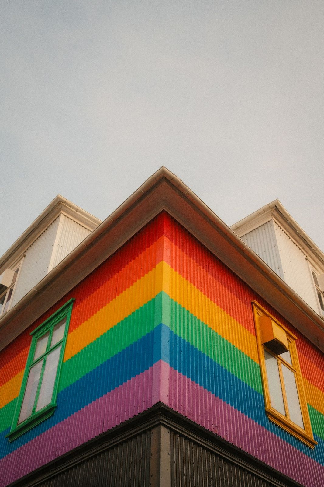 A corner of a building with rainbow striped corrugated metal siding in Reykjavík, Iceland